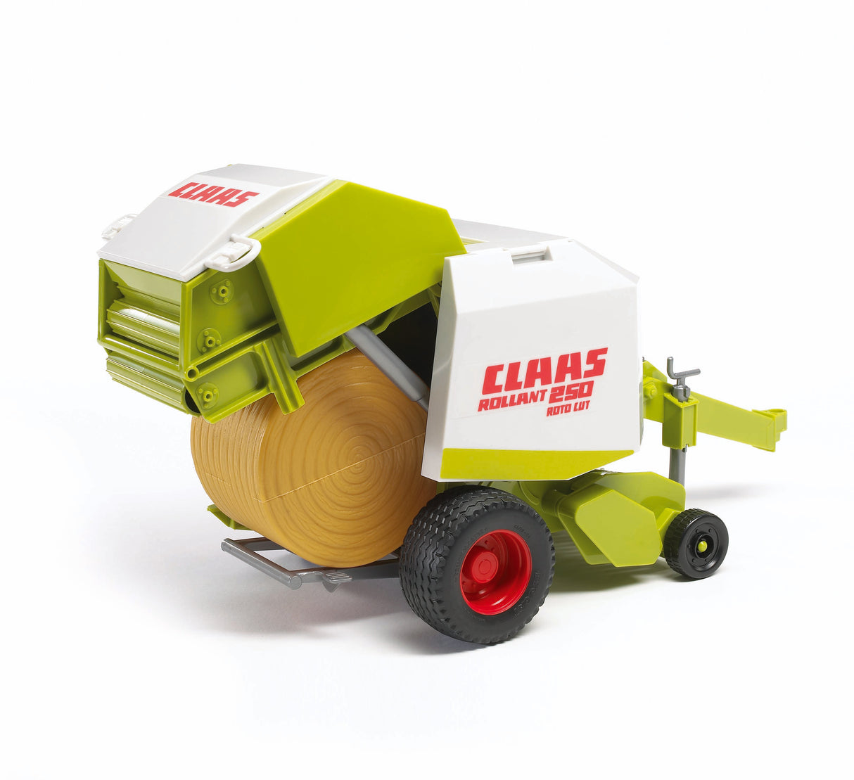 A toy model of the Claas Rollant 250 straw baler with a green and white color scheme, featuring a bale of hay and a set of tread tyres.