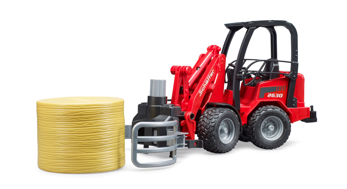 Schäffer Compact loader 2630 with bale gripper plus bale - Farm Toy