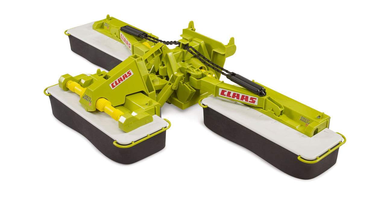 A green and yellow Claas Disc Mower Disco 8550C Plus toy tractor with oscillating suspension and rotating conditioner, designed for play.