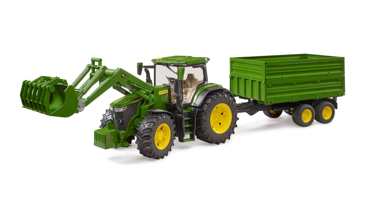A John Deere 7R 350 toy tractor with a front loader and tandem axle tipping trailer in green color, featuring realistic details and a tilting function.