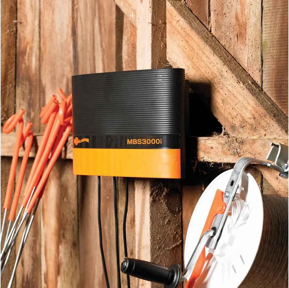 Black and orange MBS3000 device mounted on a wooden wall