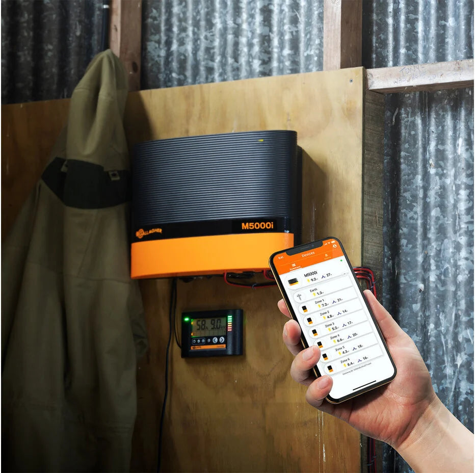 Person using a smartphone app to control a gallagher M5000i