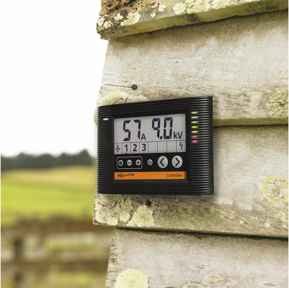 Digital meter mounted on a wooden post with a blurred natural background