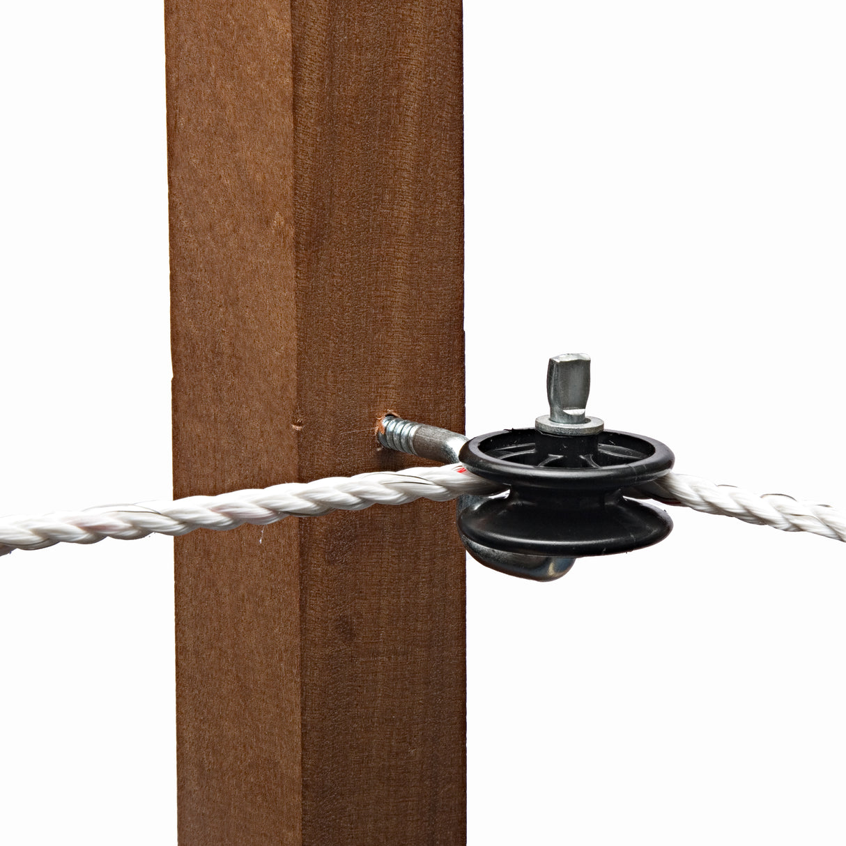A black hotline straining insulator for electric fencing, mounted on a wooden post with rope coming out of it.