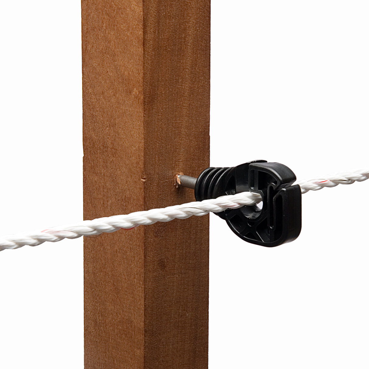 A black hotline screw-in ring insulator attached to a wooden post, with a white rope or wire fitted into the insulator.