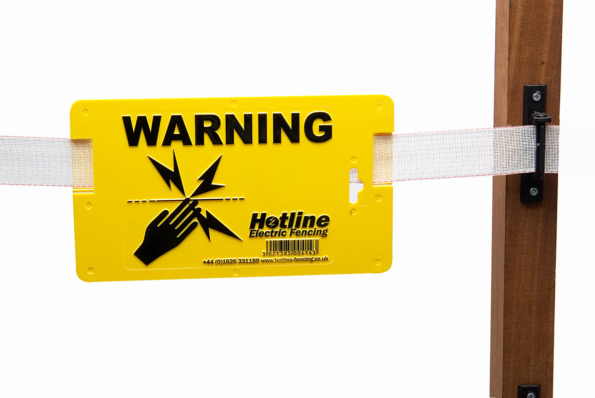 A yellow rectangular plastic warning sign with black text, attached to an electric