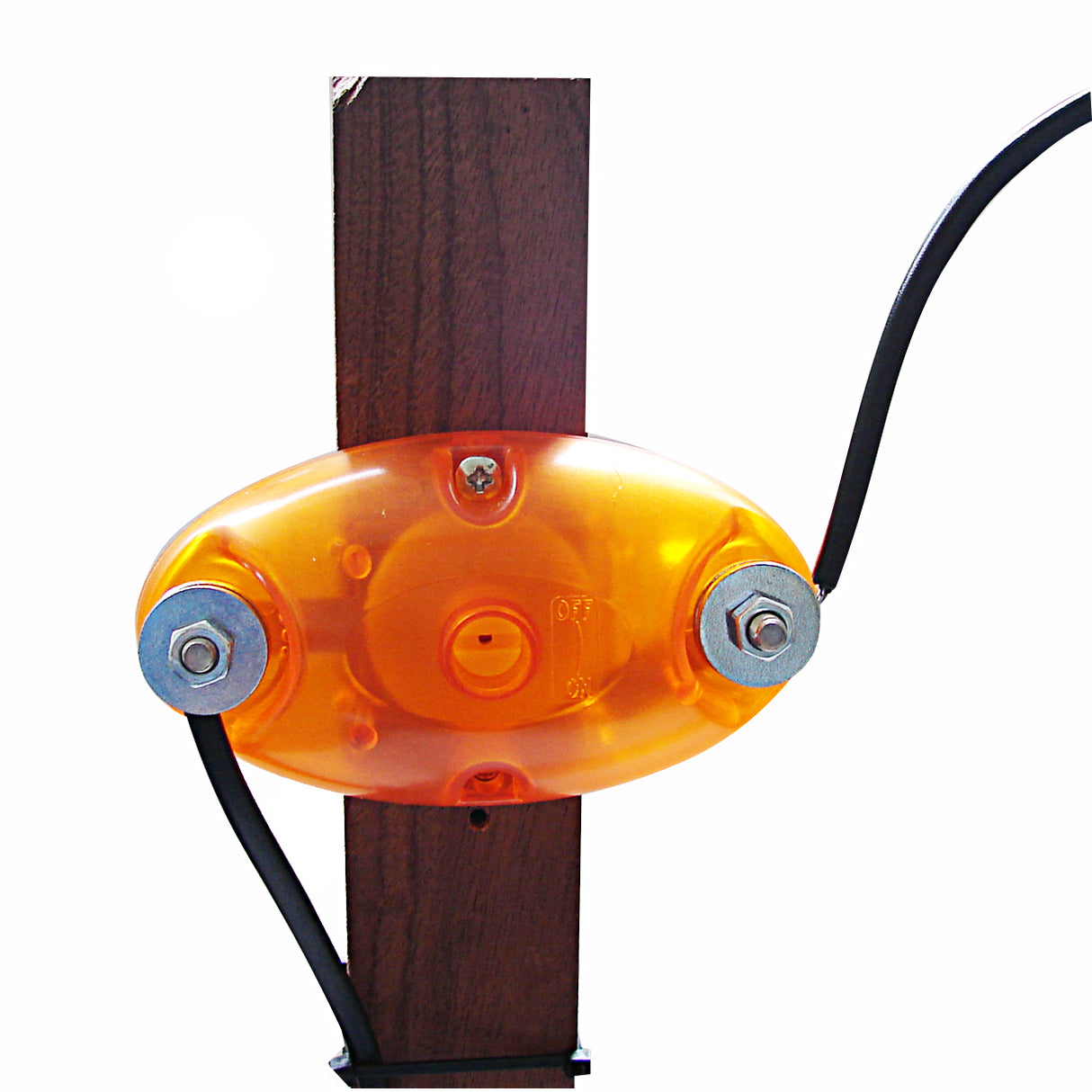A ightning arrestor device, primarily orange in color, mounted on a wooden post with a wire attached to it.