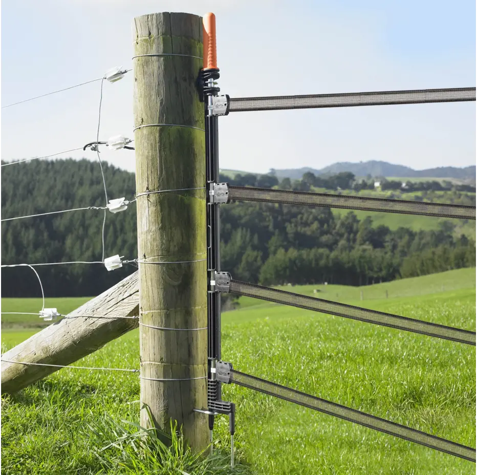 Fence post with electrical fence wires in a rural setting