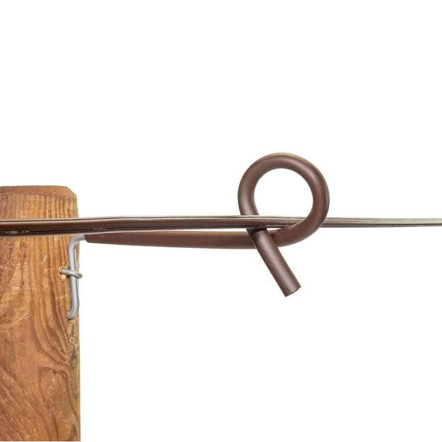 A close-up of a Gallagher offset pigtail distance insulator installed on a wooden fence post.