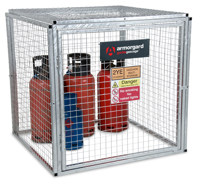 A galvanized metal security cage containing red and blue gas cylinders, with hazard warning signage attached.