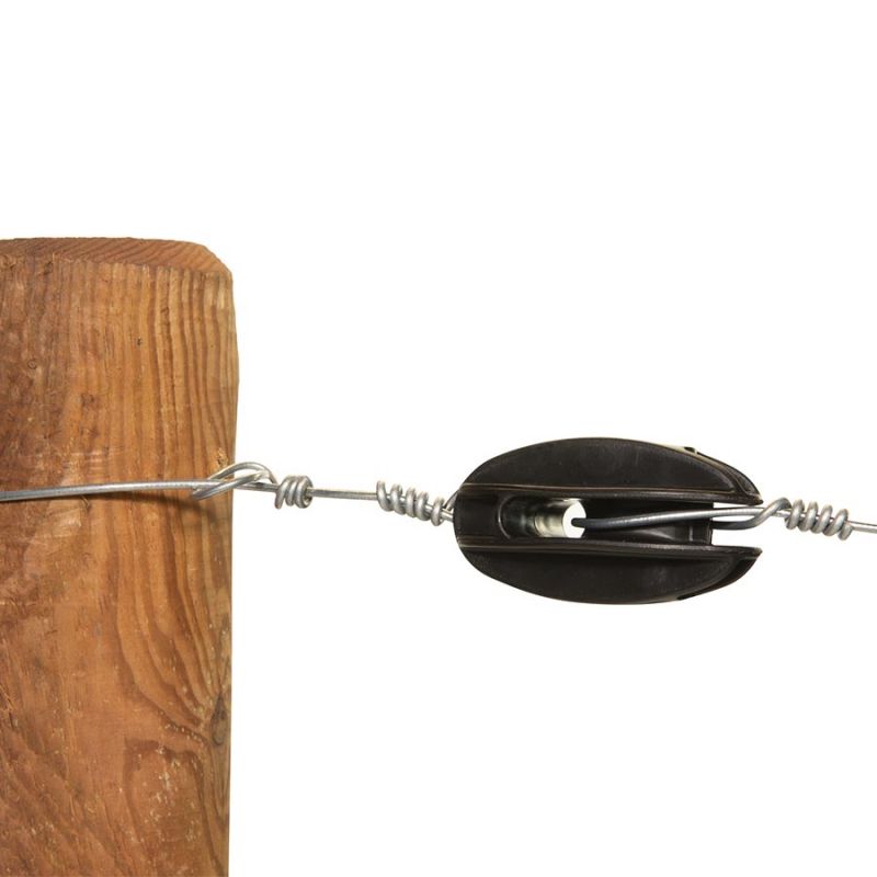 A black plastic strain insulator fitted on a wooden fence post, with a section of wire attached to it.