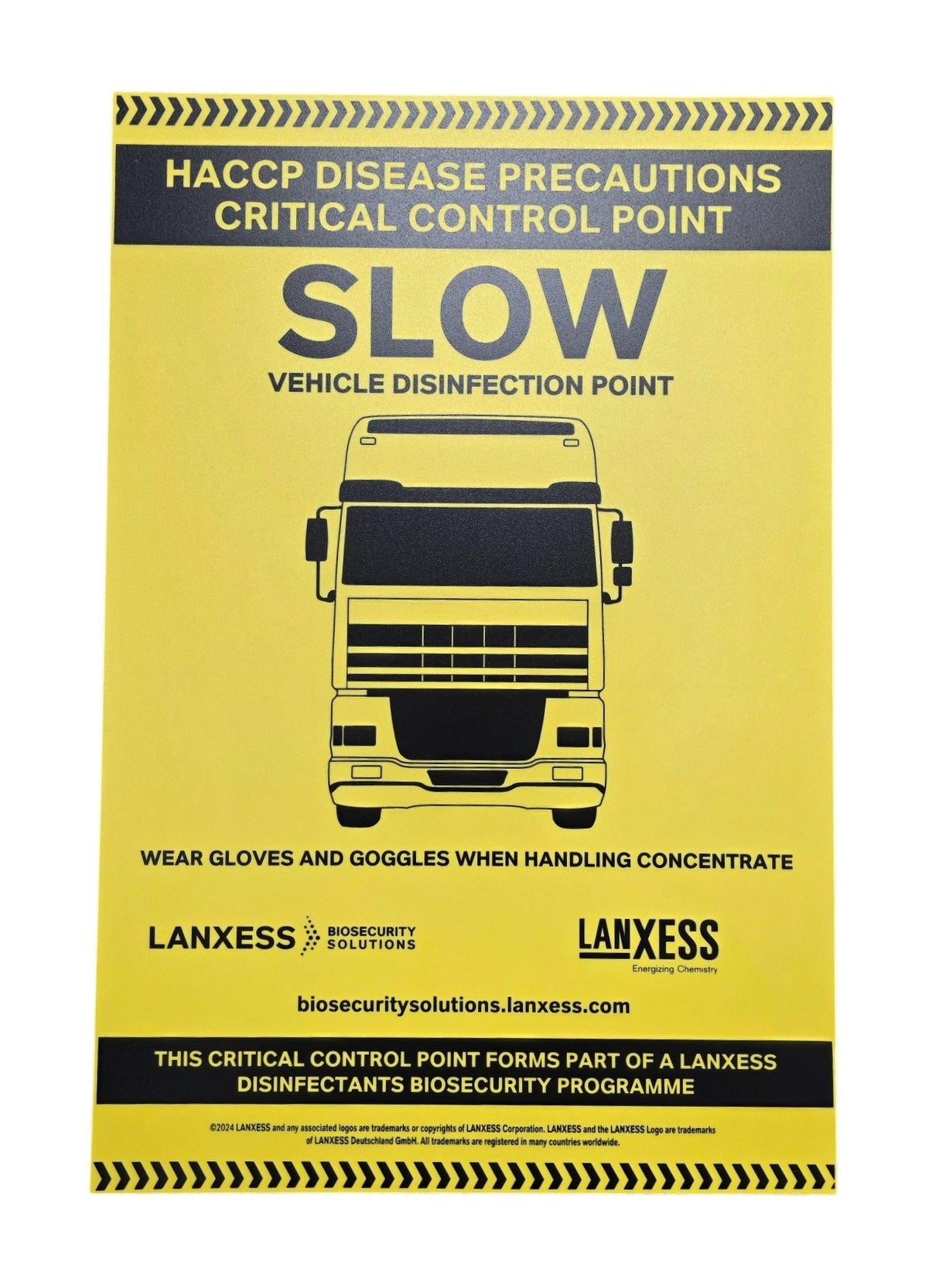A yellow sign with black and white text and graphics, providing instructions for vehicle disinfection, including wearing gloves and goggles.