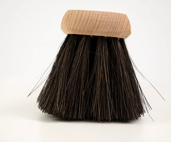 Broom with a beige handle on a white background