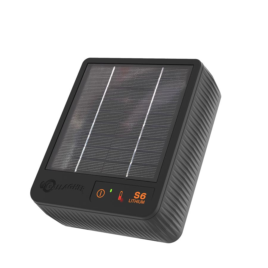 A black Gallagher S6 solar electric fence energizer with a solar panel on top and digital display on the front.