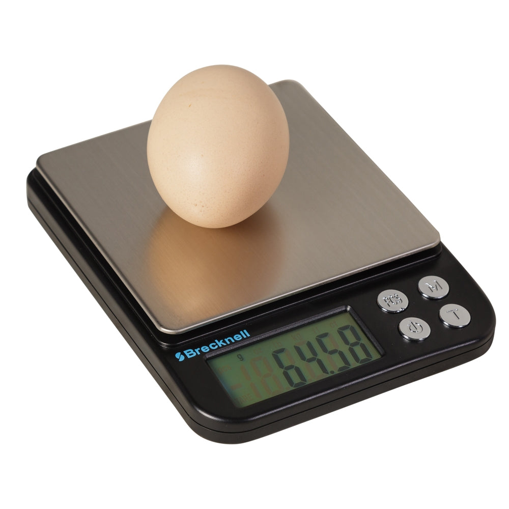 An egg on top of a digital egg weighing scale with a black platform and a digital display showing the weight.