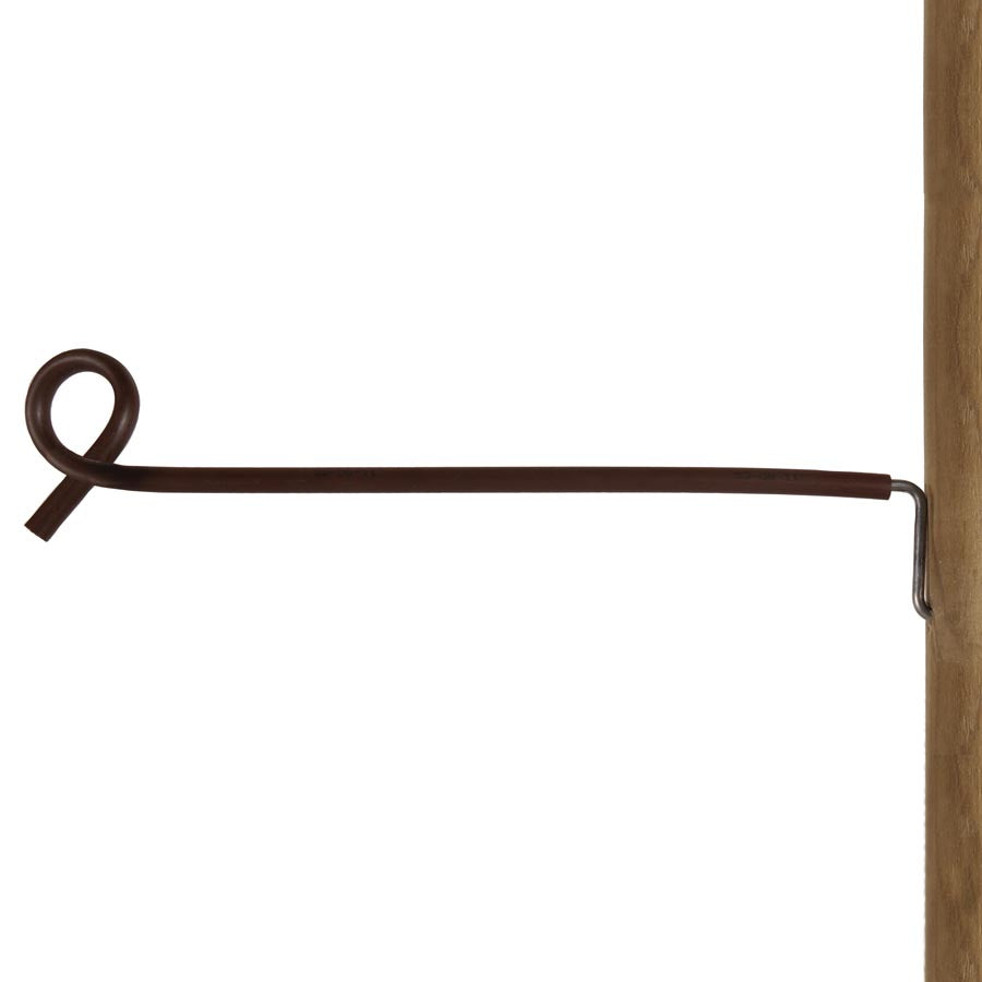 A brown offset pigtail distance insulator for electric fencing, showing a plastic insulated end and a metal staple, installed on a wooden post.