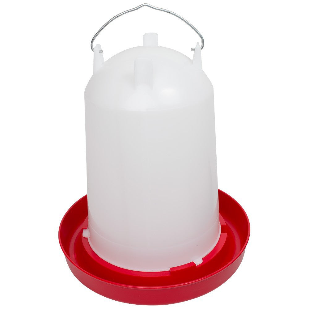 A poultry font drinker with a white upper part and a red base, equipped with a metal handle.