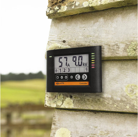 Digital meter mounted on a wooden post with a blurred natural background