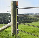 Fence post with electrical fence wires in a rural setting